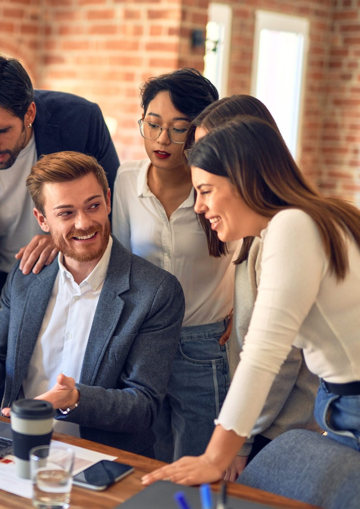 Small team collaborating in a modern office, representing Tenjin’s Intelligent Automation solution for streamlining internal business processes and enhancing employee and customer experience.